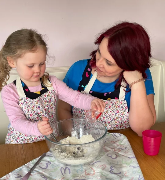 mother and daughter wearing twinning aprons